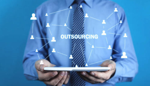 Outsource - tycoonstory | tycoonstory media Businessman holding a tablet with a digital network around the word'Outsourcing,' representing the use of outsourcing as an effective strategy to make money online and explore Internet business ideas