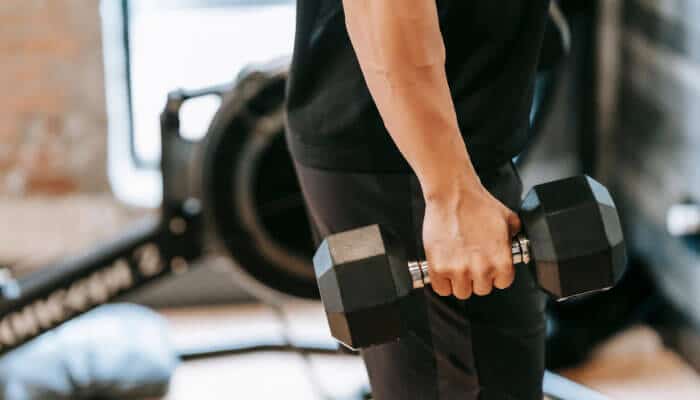 Exercise equipment for social outreach | tycoonstory media Social enterprise professional working on a laptop while reviewing documents, representing impact-driven business operations.