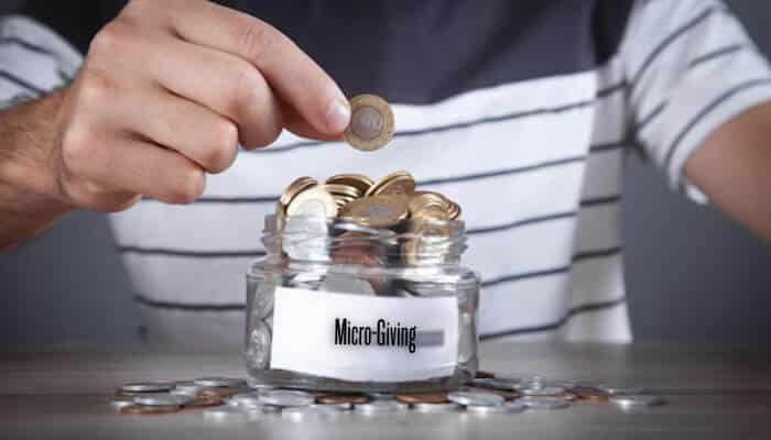 Micro-giving | tycoonstory media Social enterprise leaders discussing social products and employment opportunities during a business meeting.