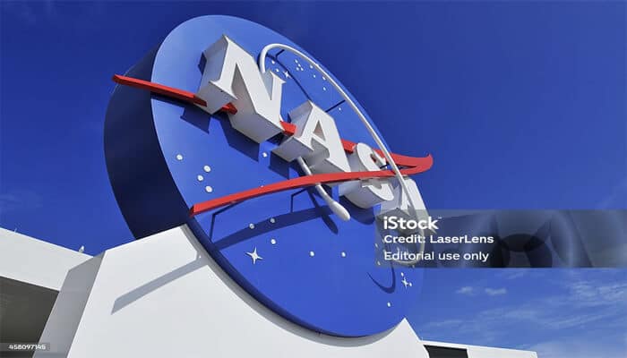 Nasa missions | tycoonstory media Close-up view of the nasa logo displayed at a nasa facility under a clear blue sky.
