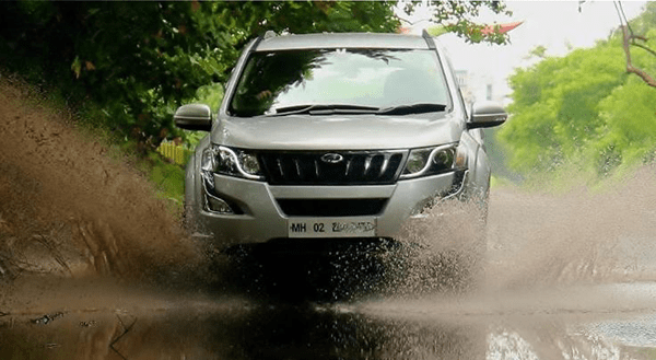 Mahindra & mahindra xuv500 A mahindra xuv500 speeding through a water-filled road, creating a dramatic splash during an off-road drive.