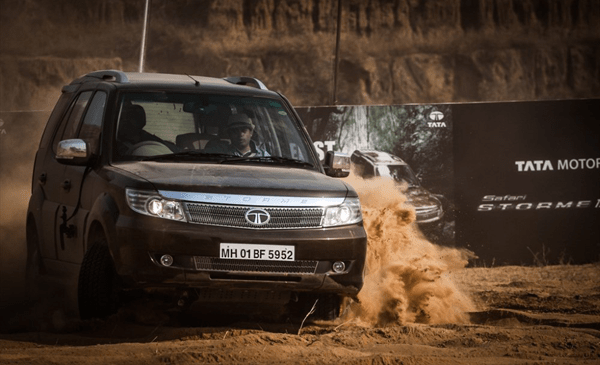 Tata safari storme Tata safari stormea tata safari storme kicking up sand while navigating rough dunes in an off-road environment.