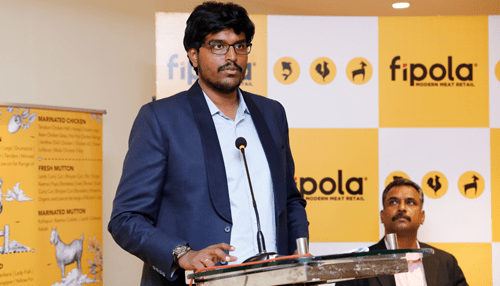 Fipola Executive speaking at a podium during an event of fipola meat retail company showcasing the brand.