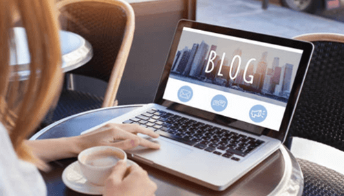 Lead generation Person working on a laptop with a blog dashboard open, illustrating content marketing and online lead generation strategies for business growth.