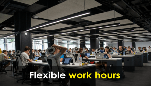 Employee-friendly office Large open workspace with employees working on computers, highlighting flexible work hours.