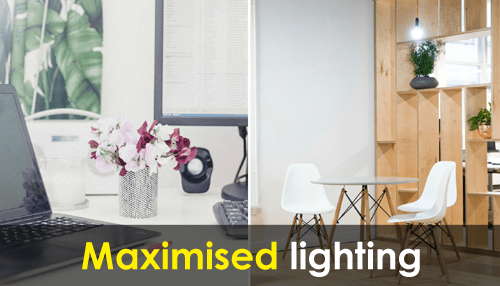 Employee-friendly office Office workspace featuring natural light, desk setup with flowers and computer screen promoting maximised lighting