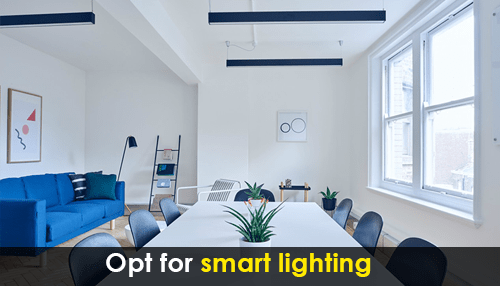 Office building's Bright meeting space with natural light and smart lighting solutions improving office building energy efficiency.