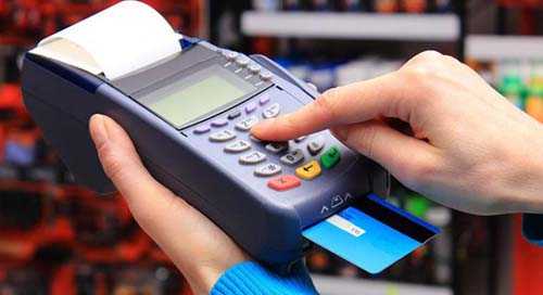 Emv payment acceptance- tycoonstory | tycoonstory media A customer inserting a card into a pos machine, illustrating secure transaction solutions in merchant services.
