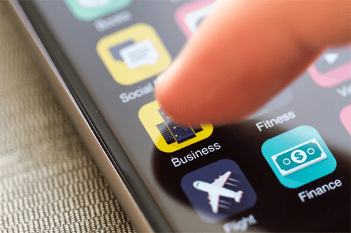 Mobile marketing agencies Close-up of a smartphone screen with various app icons, including a business app, representing the role of mobile marketing agencies in app-based promotions.