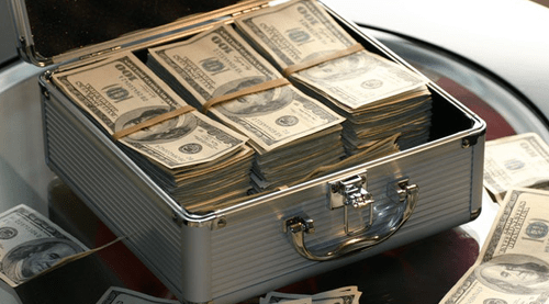 Invest fund- tycoonstory | tycoonstory media Metal briefcase filled with stacks of u. S. Hundred-dollar bills, symbolizing being financially secure.