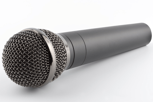 Microphone -tycoonstory | tycoonstory media Close-up of a handheld microphone showcasing audio technology used in public speaking