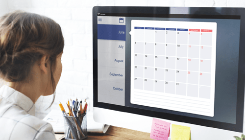 Schedule appointments service -tycoonstory | tycoonstory media Woman looking at a digital calendar on a computer screen while planning and scheduling tasks.