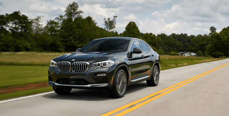 Bmw x4 Bmw x4 driving on open road highlighting performance, style, and luxury suv design