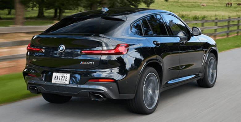 Bmw x4 sports activity -tycoonstory | tycoonstory media Bmw x4 rear exterior view showcasing sleek taillights and dynamic driving performance