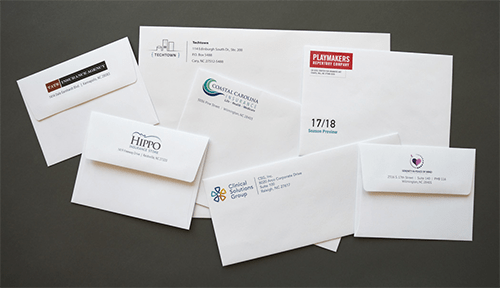 Printed envelopes Collection of custom printed envelopes featuring different company logos and branding designs, highlighting professional printed envelopes for business correspondence.