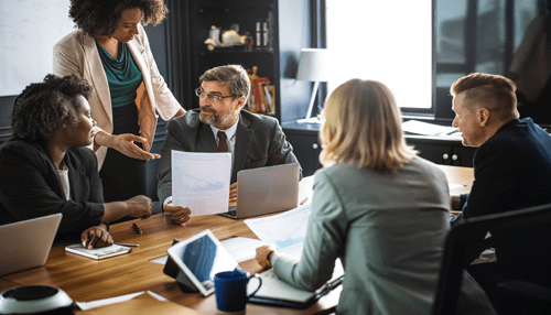 Brainstorming groups creativity in the workplace Diverse business team reviewing documents during a meeting, promoting teamwork and creativity in the workplace.
