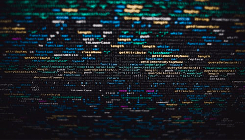 It professional A close-up view of colorful programming code displayed on a dark computer screen.