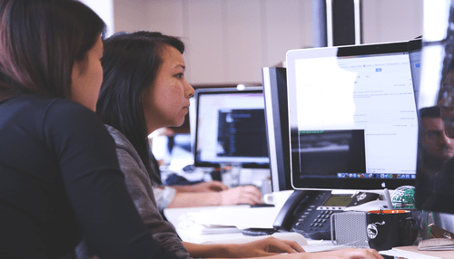 Game developers | tycoonstory media Professionals working on computers in an office environment, representing technical planning and operations behind an online casino platform.