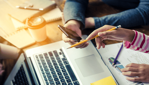 Take advantage of free seo tools - tycoonstory | tycoonstory media Marketing team collaborating on seo strategy, reviewing charts and data on a laptop to improve search engine optimization performance.