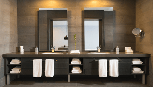 Proper habits Luxury bathroom vanity with dual mirrors, folded towels, and contemporary lighting design.