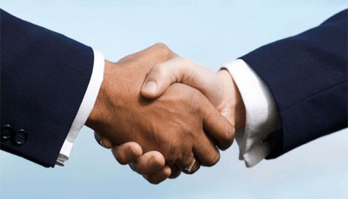 Negotiate settlements - tycoonstory | tycoonstory media Two business professionals shaking hands while facing insolvency and seeking financial agreement.