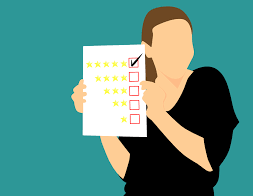How to create an effective customer feedback form Person holding a customer feedback form with a star rating system, showing the process of evaluating customer feedback.