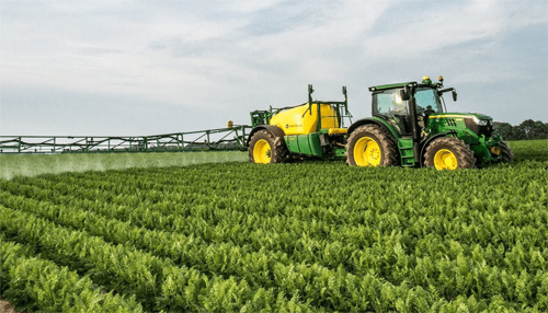 Hydraulic systems - tycoonstory | tycoonstory media Tractor spraying pesticides on farm field with hydraulic systems: a key component in modern farming, ensuring effective crop treatment with hydraulic systems.