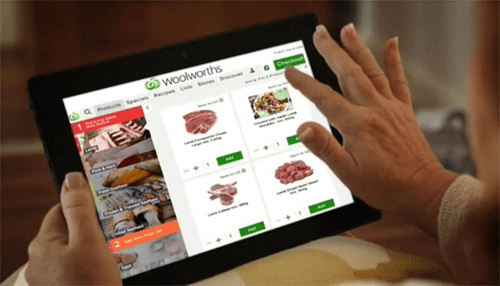 Shopping sites in south africa Person browsing woolworths online store on a tablet, exploring products available through online shopping sites in south africa.