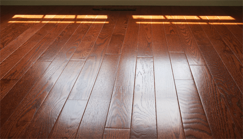 Bare flooring - tycoonstory | tycoonstory media Close-up of hardwood floor perfect for designing a bachelor pad with a sleek, modern style