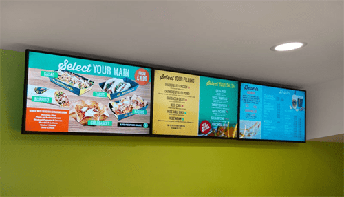 Digital signage advertising - tycoonstory | tycoonstory media Bright digital signage menu boards displaying food options and pricing in a modern restaurant setting.