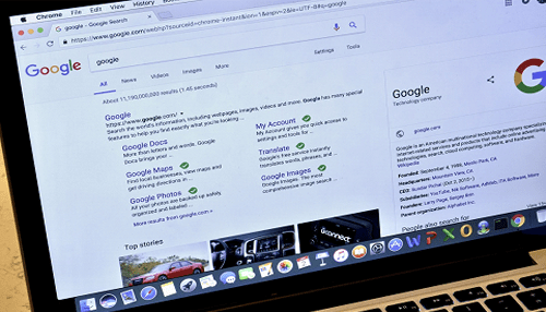 Digital advertising Laptop displaying google search results, highlighting digital advertising services and tools.