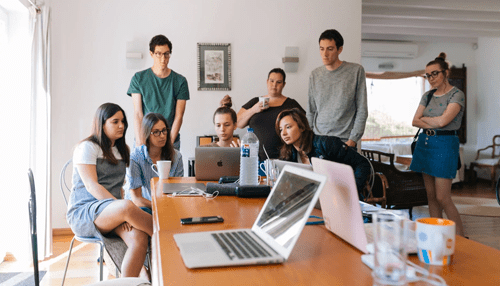 Be part of a business community entrepreneur workshop Group of individuals attending an entrepreneur workshop, collaborating around laptops and discussing ideas.