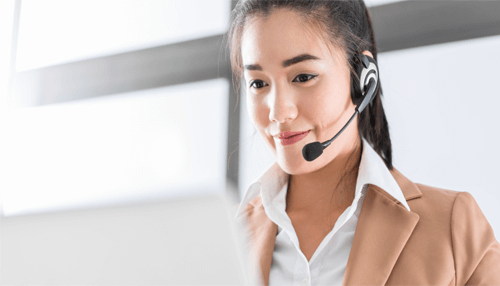 Spare time for customers Customer relationship management in action. A woman in a headset working with a laptop, representing customer service and relationship management.