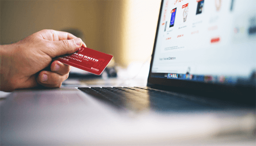 Contactless mode of payment - tycoonstory | tycoonstory media A diverse team of three business professionals collaborating around a wooden table covered in printed growth charts and analytical financial data, illustrating a team-driven strategy session for a growing business.