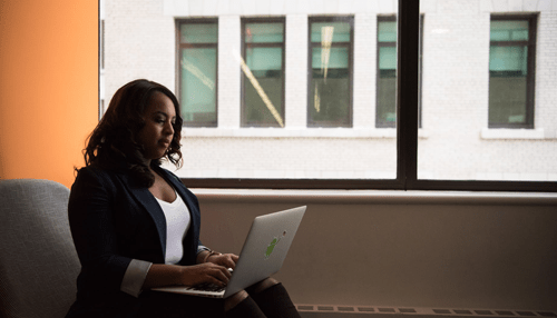 Focused woman working on a laptop in a bright office environment, symbolizing remote access solutions and productivity Collaboration opportunities through remote access solutions