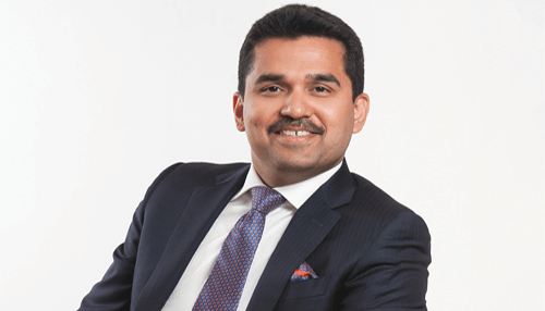 Young business tycoons Shamsheer vayalil portrait in formal suit, healthcare entrepreneur and business leader.