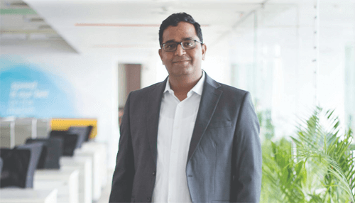 Young business tycoons Business tycoons profile image of vijay shekhar sharma, founder of paytm, standing in modern office environment.