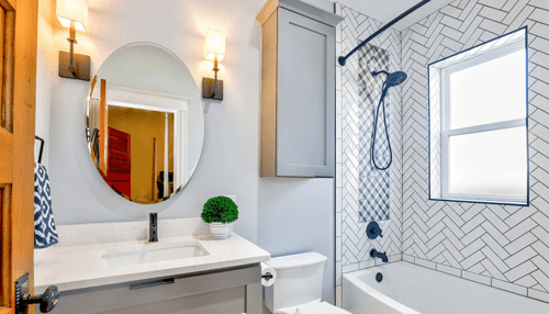 Frame the tile shower - tycoonstory | tycoonstory media A modern bathroom featuring a mosaic tile design on the shower wall, with a clean, stylish aesthetic and elegant lighting.