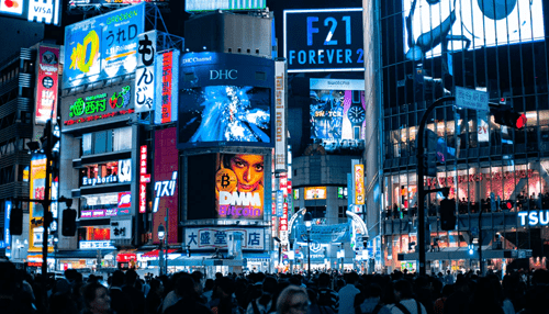 Advertising media Busy city street with bright and colorful digital billboards displaying various advertisements, showcasing vibrant advertising media in a bustling environment