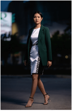 What to wear Confident woman wearing a stylish blazer and dress outfit, an example of trendy wear for business settings.