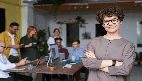 Women entrepreneurship A confident female leader standing in front of her team in a collaborative workspace, representing the empowering growth of women entrepreneurship in business.