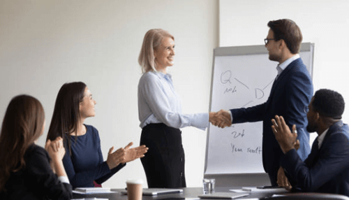Intrapreneurship Business professionals shaking hands during a meeting — symbolizing intrapreneurship vs entrepreneurship in corporate settings.