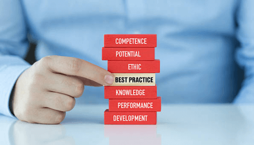 Maintaining business operations-tycoonstory | tycoonstory media Business continuity plan concept showing a hand balancing blocks labeled competence, ethics, best practice, knowledge, performance, and development to represent maintaining operations during disruption.