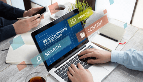 Sem versus ppc-tycoonstory | tycoonstory media A person working on a laptop displaying search engine marketing (sem), with icons representing search, marketing, and content, illustrating the integration of seo, sem and ppc in digital marketing.