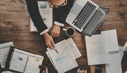 Small business investment companies - tycoonstory | tycoonstory media Close-up of a financial team analyzing market data and equity finance reports to make informed business decisions.