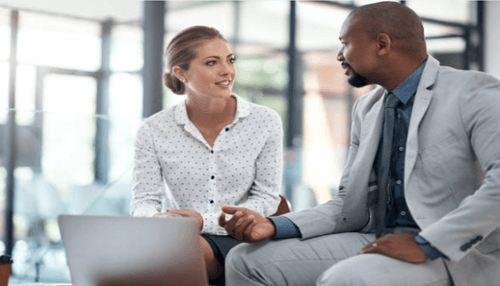 Business mentor A business mentor conversing with a client in an office setting, demonstrating a mentor-mentee relationship focused on professional growth and advice.