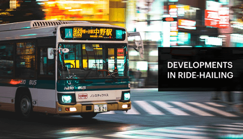 Developments in ride-hailing - tycoonstory | tycoonstory media Smart mobility advancements in ride-hailing services featuring a bus on a busy city street at night