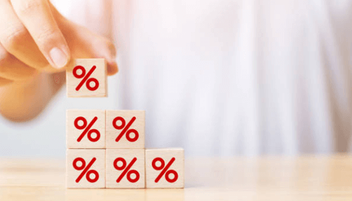 Mezzanine financing-tycoonstory | tycoonstory media Wooden blocks with percentage symbols stacked upward showing increasing interest rates, symbolizing mezzanine debt cost and repayment terms