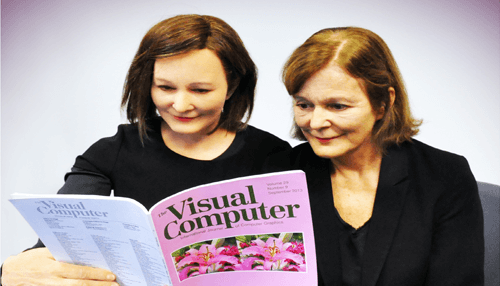 Humanoid robots Two elderly women reading a magazine where one is actually a lifelike robot – real-world example of humanoid robots in daily life.
