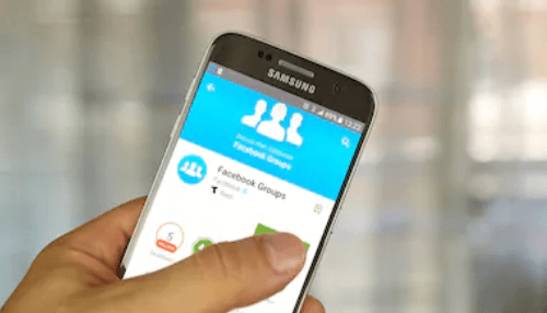Scheduling: social media account Hand holding a samsung phone showing the facebook groups app on the screen.